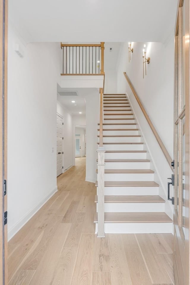 stairs featuring wood-type flooring