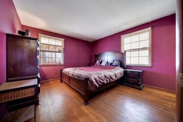 bedroom featuring multiple windows and light hardwood / wood-style floors