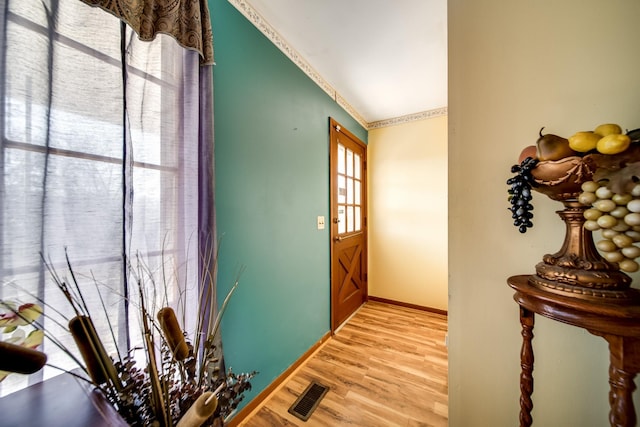 entryway with lofted ceiling and light hardwood / wood-style flooring