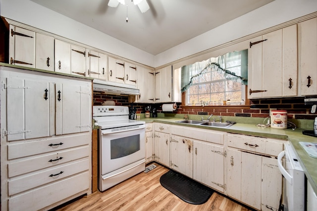 kitchen featuring sink, white range with electric cooktop, tasteful backsplash, cream cabinetry, and light wood-type flooring