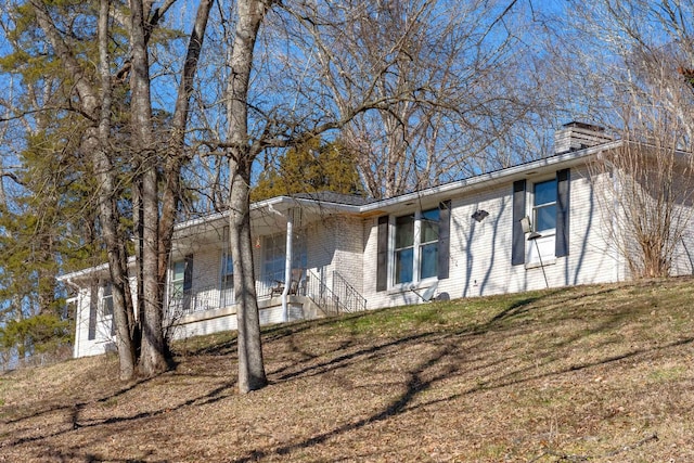 view of home's exterior featuring a lawn and a porch