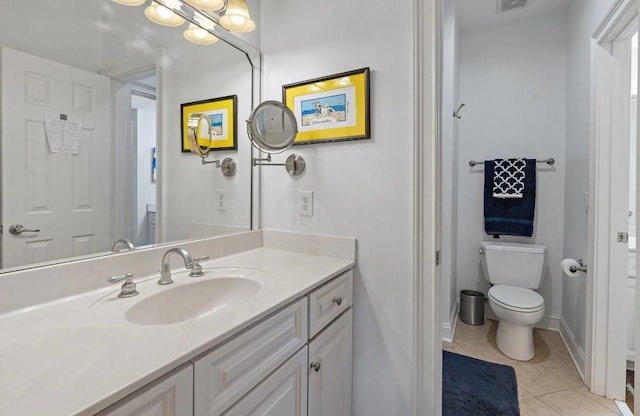 bathroom featuring vanity, toilet, and tile patterned flooring