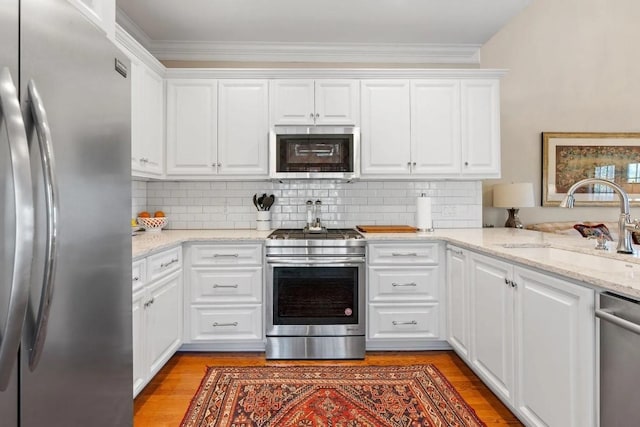 kitchen featuring stainless steel appliances, sink, and white cabinets