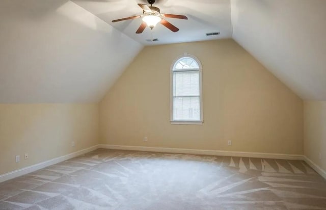 bonus room featuring vaulted ceiling, light carpet, and ceiling fan