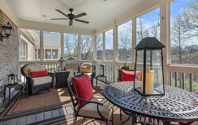 sunroom featuring ceiling fan and a wealth of natural light