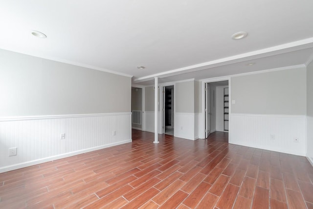 unfurnished room featuring wood-type flooring and crown molding