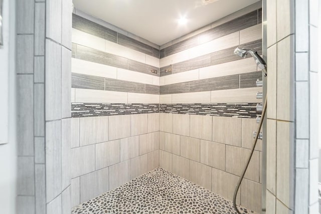 bathroom with a tile shower