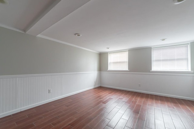 spare room featuring ornamental molding and dark hardwood / wood-style floors