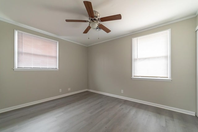 empty room featuring ornamental molding, wood-type flooring, a healthy amount of sunlight, and ceiling fan