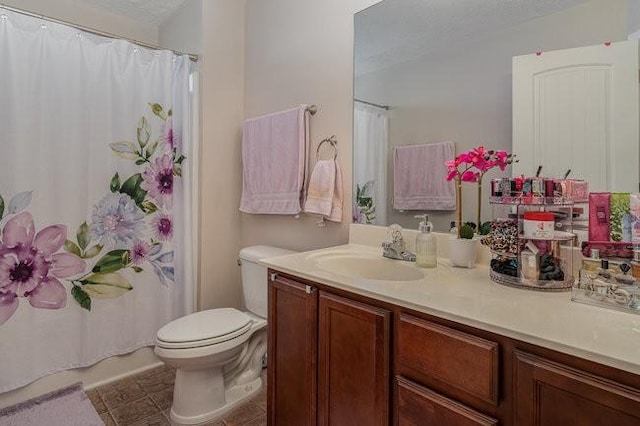 bathroom featuring vanity, tile patterned flooring, curtained shower, and toilet