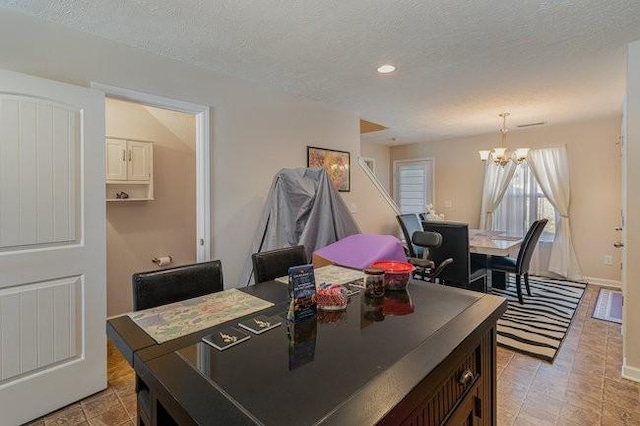 interior space with a chandelier and a textured ceiling