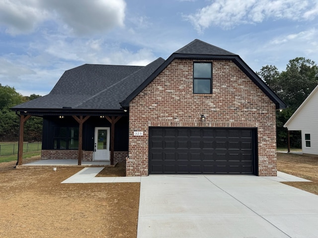 view of front facade featuring a garage and covered porch