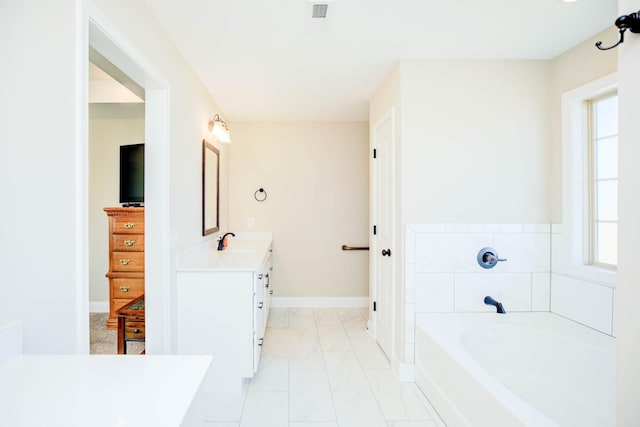 bathroom with vanity and a washtub