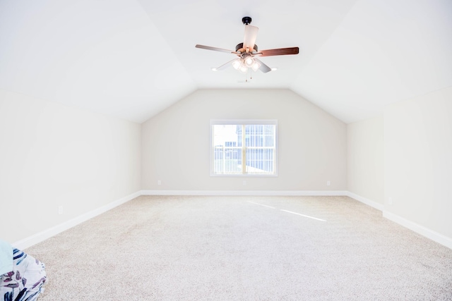 bonus room with vaulted ceiling, carpet flooring, and ceiling fan