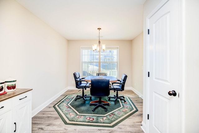 dining room featuring an inviting chandelier and light hardwood / wood-style flooring