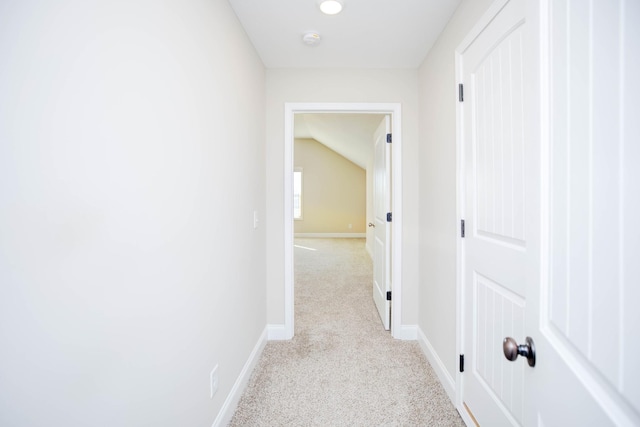 hallway featuring light colored carpet