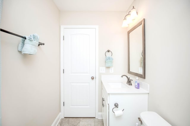 bathroom with vanity, toilet, and tile patterned flooring