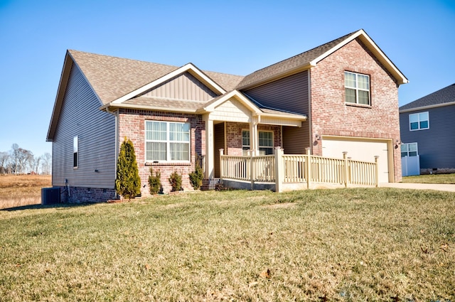 view of front facade with a garage, a porch, central air condition unit, and a front lawn