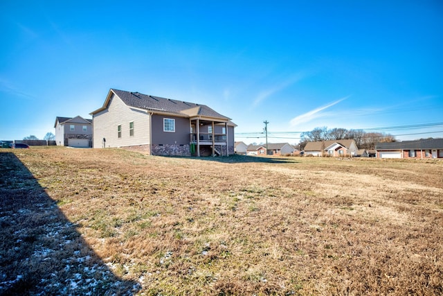 back of property featuring a lawn