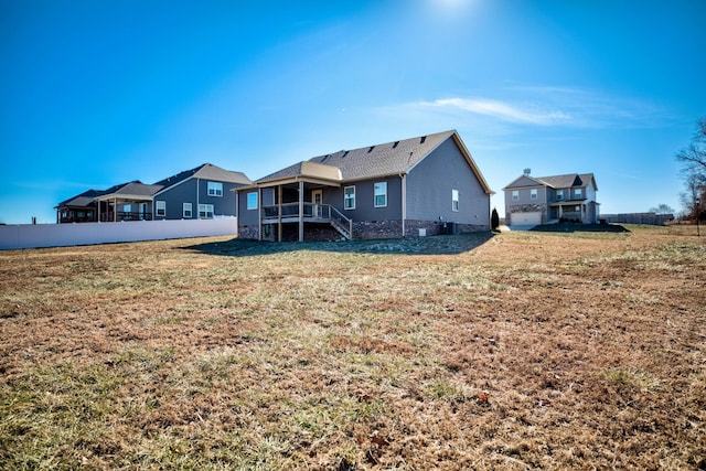 rear view of property featuring a yard