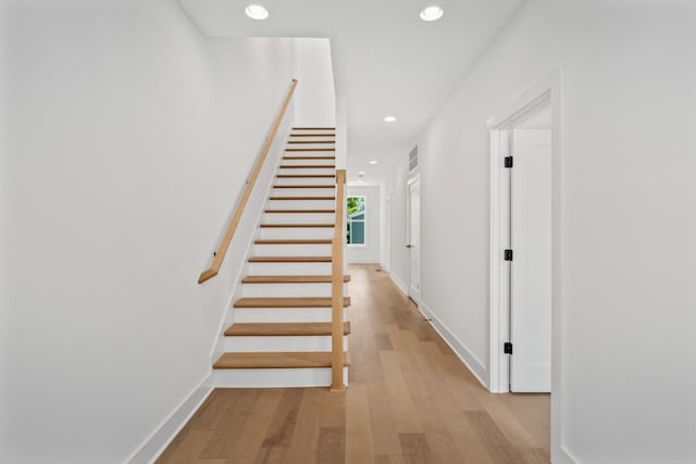 stairs with hardwood / wood-style floors