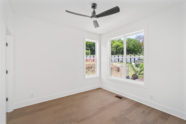 empty room featuring hardwood / wood-style flooring and ceiling fan