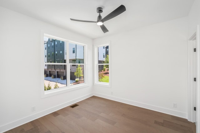 unfurnished room with hardwood / wood-style flooring and ceiling fan