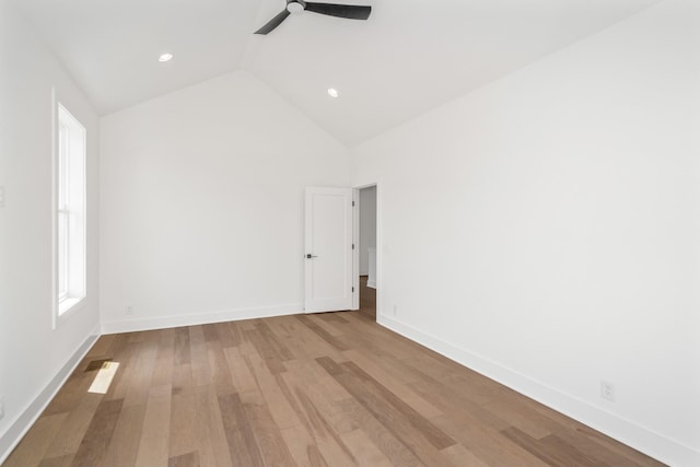 unfurnished room with ceiling fan, lofted ceiling, and light wood-type flooring