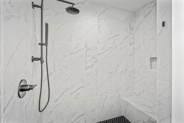 bathroom with a tile shower