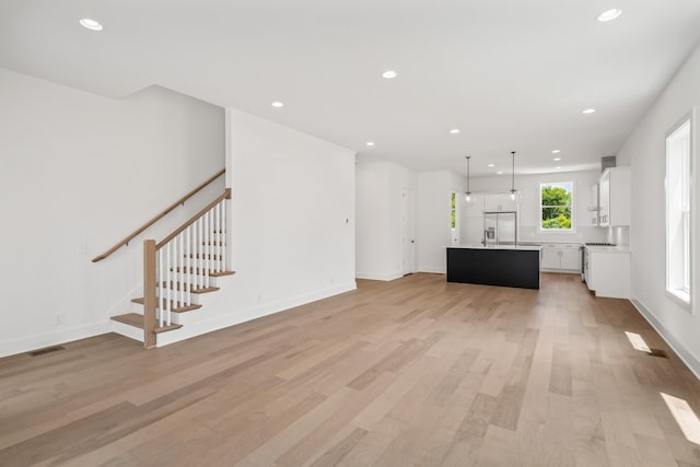 unfurnished living room featuring light hardwood / wood-style floors