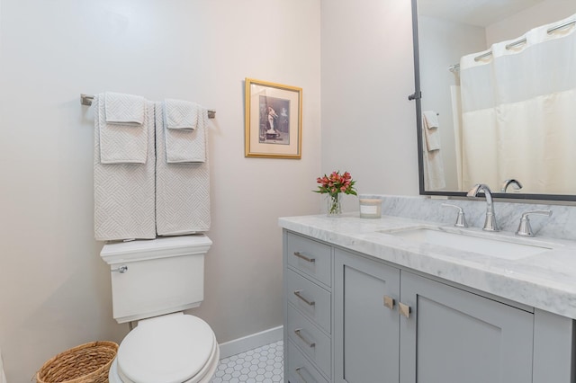 bathroom featuring tile patterned floors, vanity, and toilet