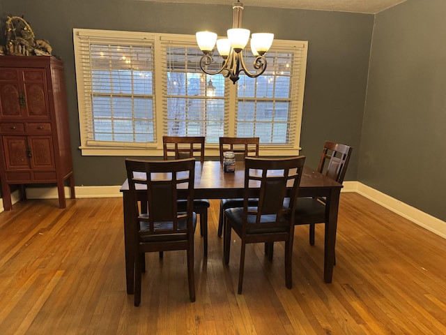 dining area featuring a notable chandelier and hardwood / wood-style flooring