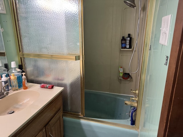 bathroom featuring vanity and shower / bath combination with glass door