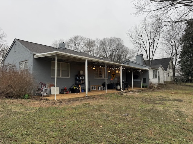 rear view of property featuring a yard and a patio