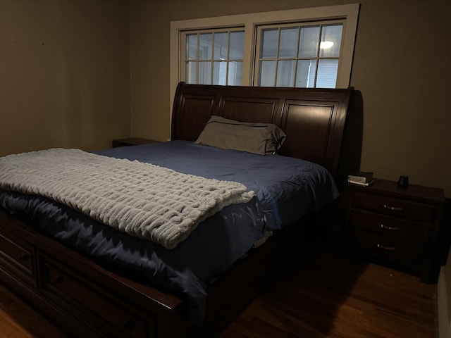 bedroom with dark hardwood / wood-style flooring