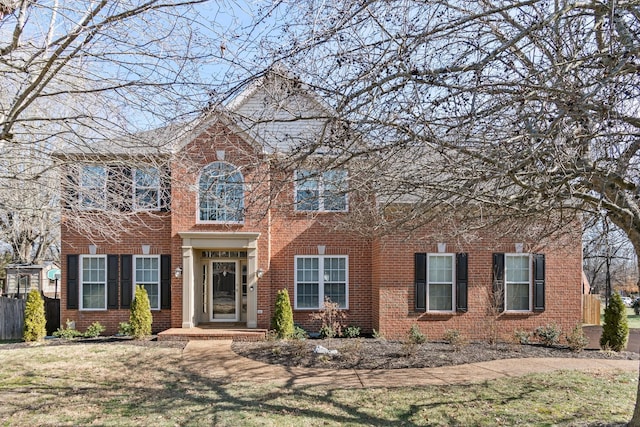 colonial home with a front lawn