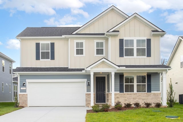 craftsman house featuring a garage, a front yard, and cooling unit