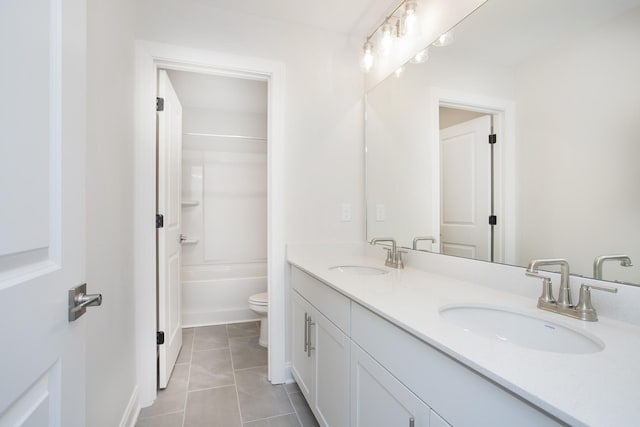 full bathroom with vanity, tile patterned floors, toilet, and washtub / shower combination