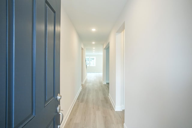 corridor with light hardwood / wood-style flooring