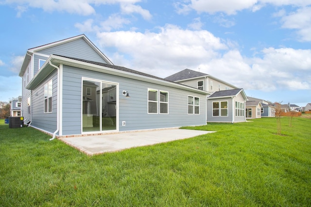 back of house featuring a yard, central AC unit, and a patio area