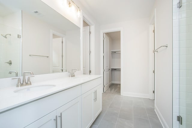 bathroom with tile patterned floors, a shower with shower door, and vanity