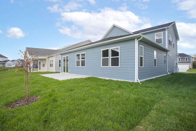 back of property featuring a yard and a patio