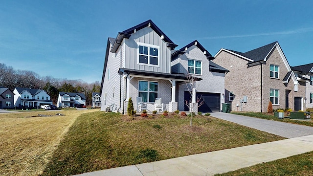 view of front facade with a garage, a front lawn, and covered porch