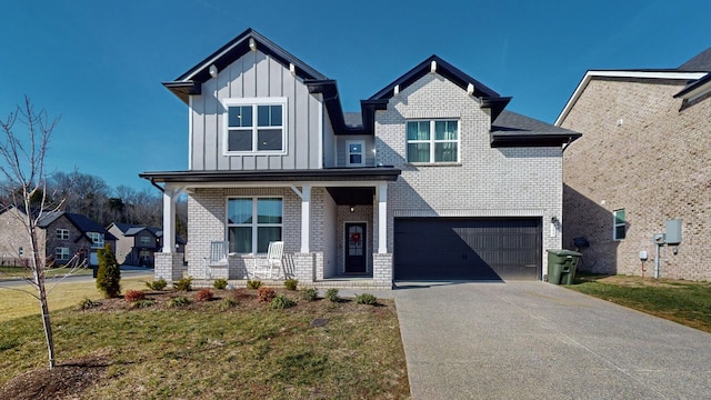 view of front of property featuring a garage, covered porch, and a front lawn