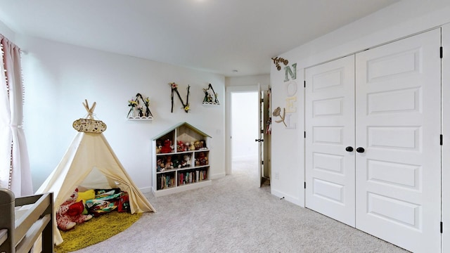 recreation room with light colored carpet