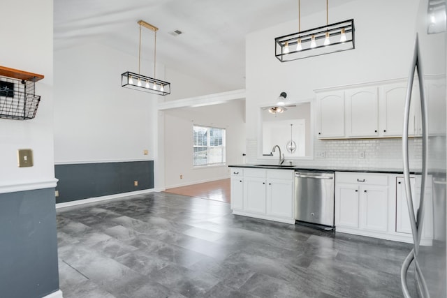 kitchen featuring white cabinetry, tasteful backsplash, stainless steel appliances, and hanging light fixtures