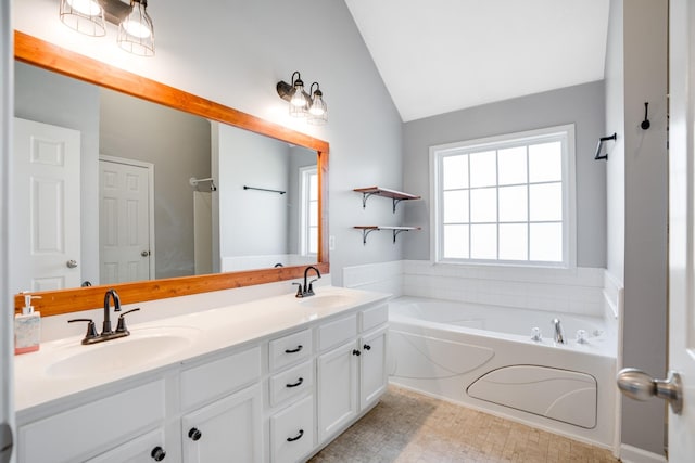 bathroom featuring vanity, lofted ceiling, and a bathtub