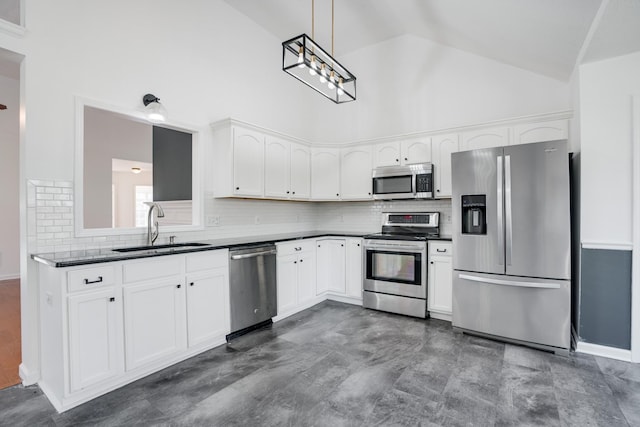 kitchen with high vaulted ceiling, white cabinetry, sink, hanging light fixtures, and stainless steel appliances