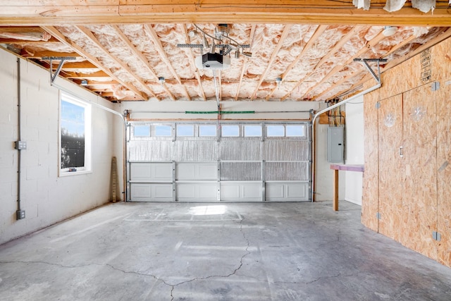 garage featuring a garage door opener and electric panel