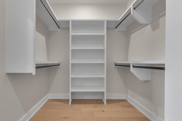 spacious closet with light hardwood / wood-style floors